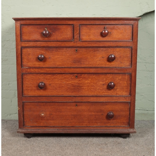 584 - An oak two over three chest of drawers.