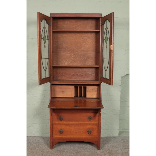 586 - An oak bureau bookcase with leaded and stained glass top. 206 x 80 x 39cm