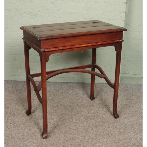 592 - A 20th century mahogany metamorphic table/desk. Height 81cm, Width 74cm, Depth 44cm.