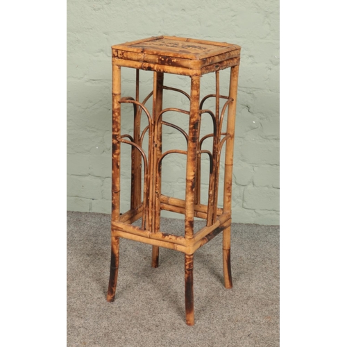 594 - A bamboo plant stand. Height 72cm.