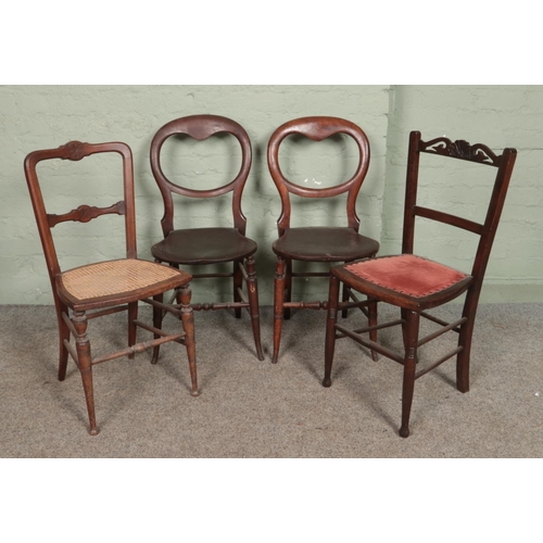 599 - Seven antique chairs. Includes rush seat hall chair, pair of balloon backs, rocking chair etc.