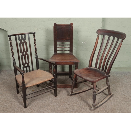 599 - Seven antique chairs. Includes rush seat hall chair, pair of balloon backs, rocking chair etc.