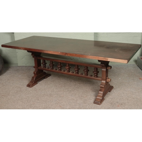 600 - A large dark oak dining table. With spindle stretcher base. Dimensions of table - Length: 200cm, Hei... 