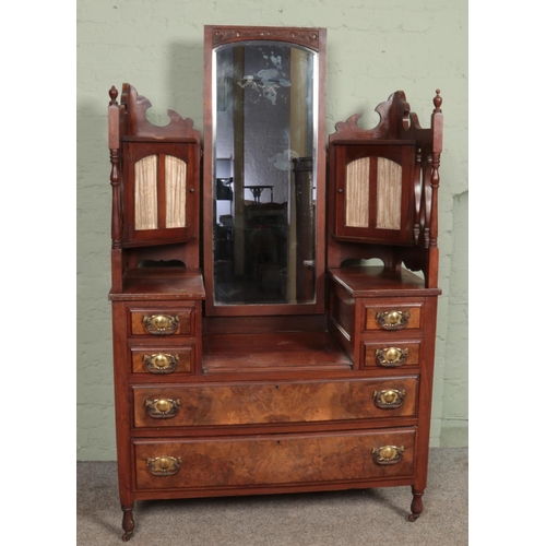 601 - A late nineteenth/early twentieth century walnut dressing table, raised on casters and with turned s... 