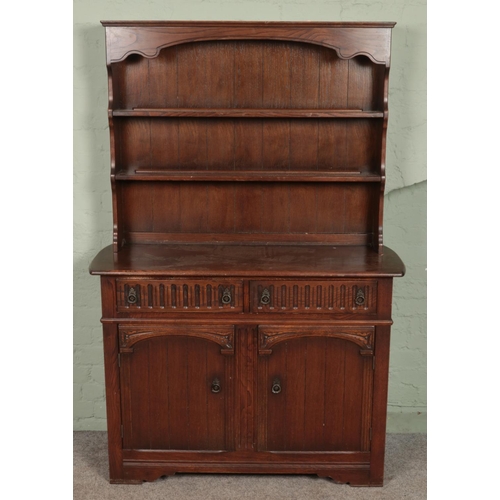 607 - A carved oak dresser. (180cm x 121cm)