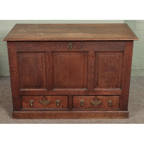 618 - A 19th century oak mule chest with triple panelled front and two drawers with tear drop handles and ... 