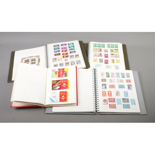 118 - Four albums of assorted world stamps to include Europa, St. Vincent, The Caribbean, The Falkland Isl... 