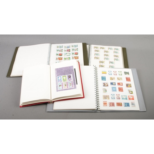 118 - Four albums of assorted world stamps to include Europa, St. Vincent, The Caribbean, The Falkland Isl... 