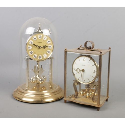 144 - A Kundo torsion clock along with a London Clock quartz example.