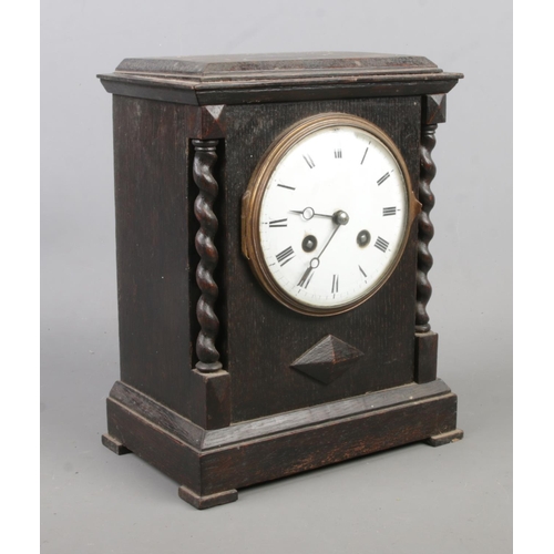 146 - A French oak mantel clock with barley twist decoration and Japy Freres movement. Height 24cm.
