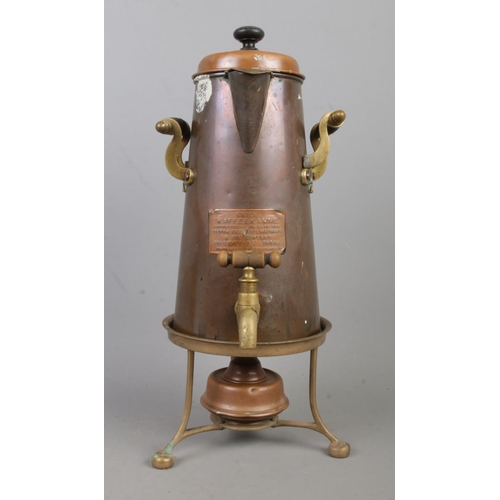 151 - A copper and brass coffee pot, with burner and trivet. Labelled for Ash's Kaffeekanne, manufactured ... 