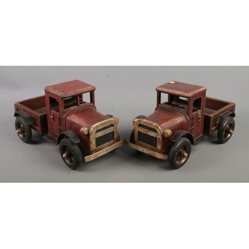 176 - A pair of wooden toy trucks 

32cm long