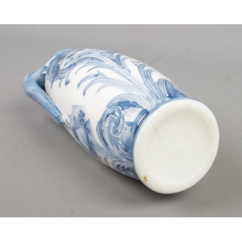 208 - A blue and white twin handled vase in the style of Macintyre. Approx. height 21.5cm