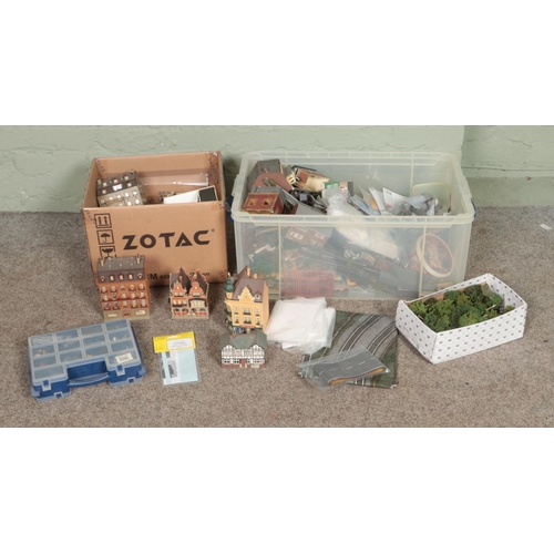 277 - Two boxes of assorted model railway scenery, buildings and diorama supplies. Includes foliage, layou... 