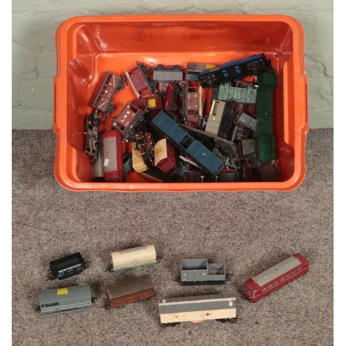 279 - A box of Tri-Ang and Marklin OO Gauge rolling stock to include carriages, tankers, wagons, etc.