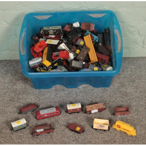 280 - A box of assorted model railway stock of mostly OO Gauge to include carriages, wagons and tankers.