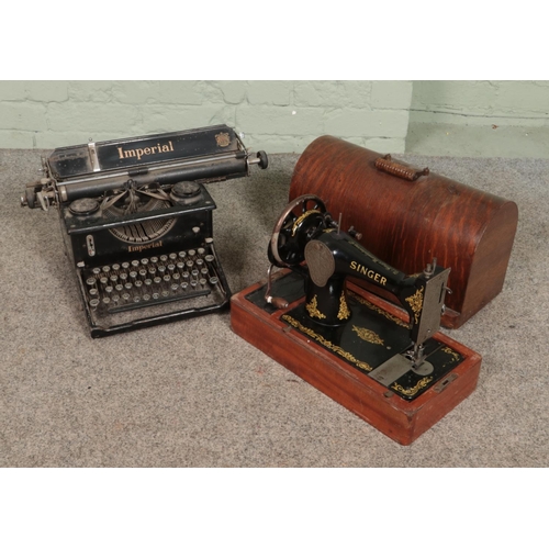 289 - An early 20th century Imperial typewriter along with a cased hand crank Singer sewing machine.