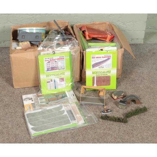 297 - Two boxes of assorted model railway scenery to include buildings, background decor, etc.