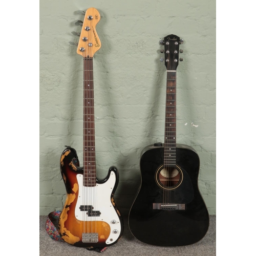 311 - A Fender acoustic guitar (DG-5BLK) along Encore bass guitar Blaster Series.