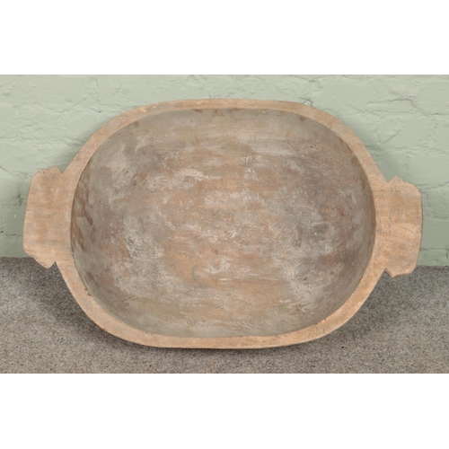 322 - A large wooden dough bowl.

84cm long