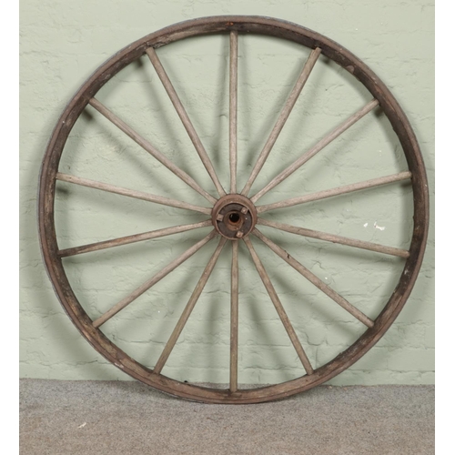 327 - A large wooden cartwheel, with fourteen spoke design. 124cm diameter.