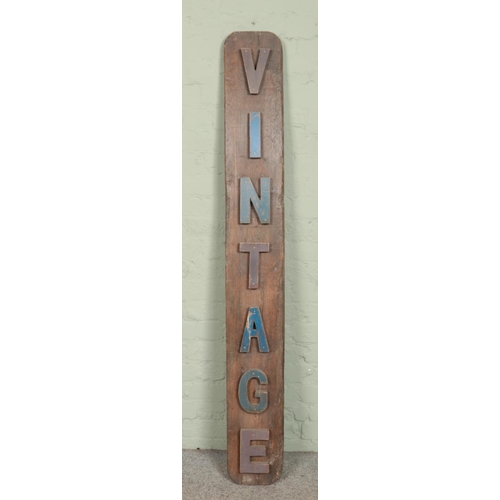 338 - A large wooden sign 'Vintage'. Length 174cm.