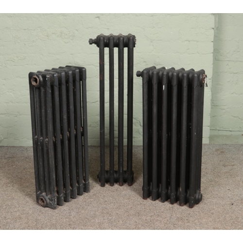 352 - Three painted cast iron radiators. Includes two six bar and one four bar example.