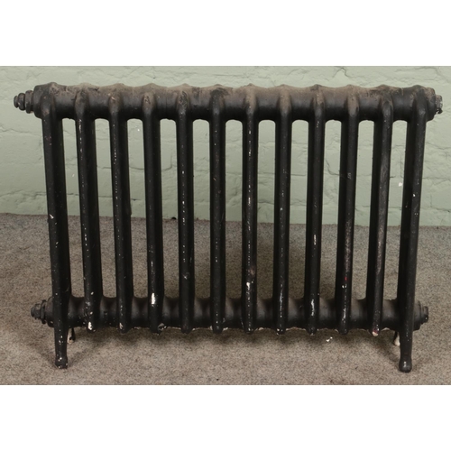 353 - A large cast iron radiator. (62cm x 87cm)