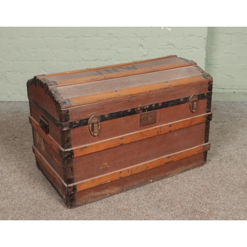 354 - A vintage wood bound travel trunk. Stencilled to the top JNW.