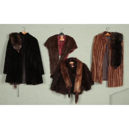 356 - A collection of real and faux fur coats, capes and stoles. Includes silver fox stole example, etc.