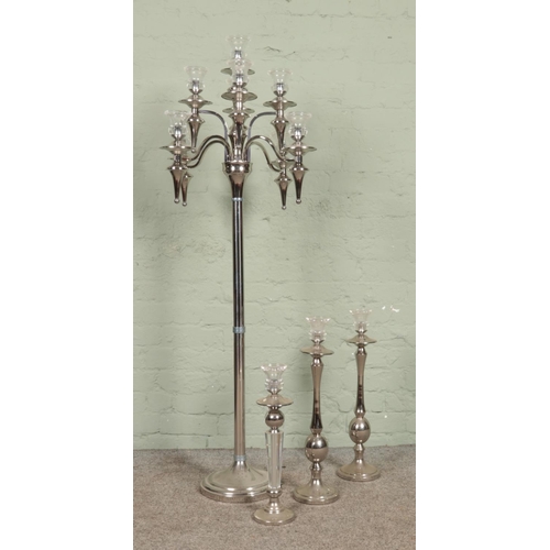 378 - A large chromed eight branch standing candelabra, together with three chromed candlesticks of simila... 