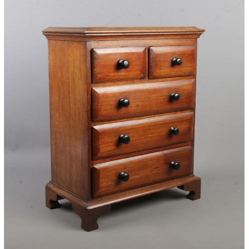 379 - A miniature mahogany chest of drawers in the Victorian style. 44cm x 34cm x 19cm.