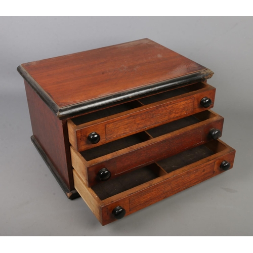 384 - A mahogany table top three drawer specimen chest. 25cm x 43cm x 30cm.