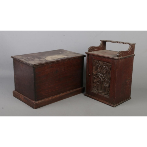 385 - A carved oak smokers cabinet along with a wooden box.