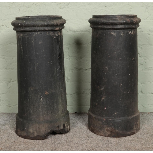 390 - Two painted chimney pots, with false tops, used as planters. 71cm tall.