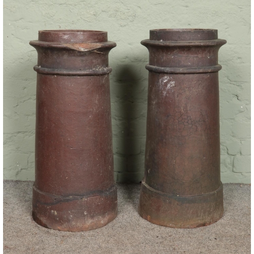 391 - Two cylindrical chimney pots. 76cm tall.