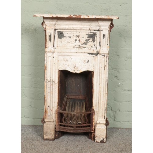 393 - A Victorian painted cast iron bedroom fireplace. 91cm x 58cm.