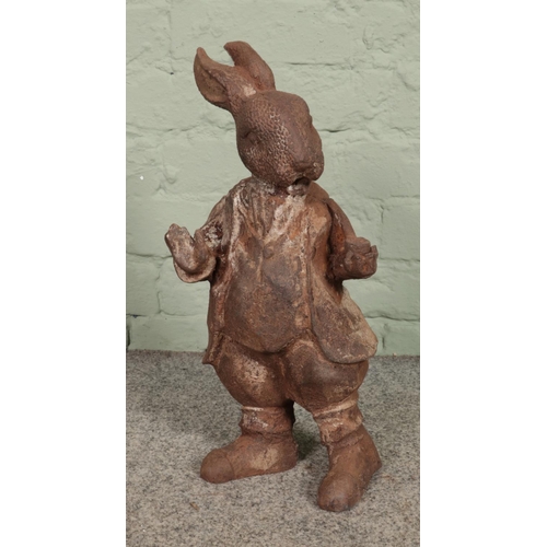 407 - A rusted cast iron garden ornament of Mr. Rabbit, from Wind in the Willows. 44cm high.