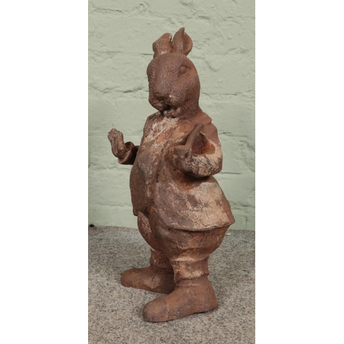 407 - A rusted cast iron garden ornament of Mr. Rabbit, from Wind in the Willows. 44cm high.