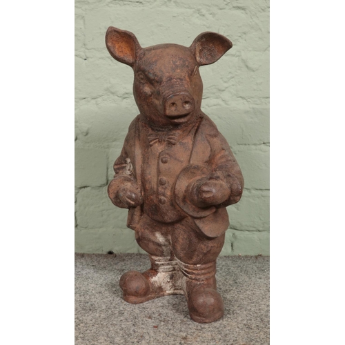 409 - A rusted cast iron garden ornament of 'Mr. Pig', in the same style as a Wind in the Willows characte... 