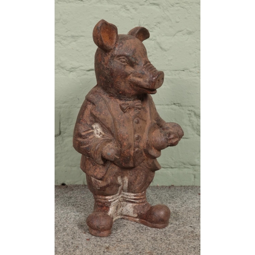 409 - A rusted cast iron garden ornament of 'Mr. Pig', in the same style as a Wind in the Willows characte... 