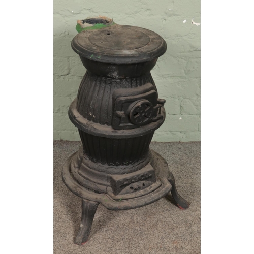 423 - A cast iron pot belly stove. (63cm)