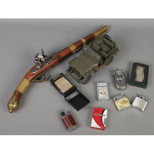 63 - A small quantity of collectables. Mostly lighters. Includes cased Zippo Marlboro example, replica pi... 