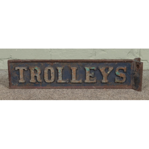 72 - A painted cast iron 'Trolleys' sign. 64cm long.