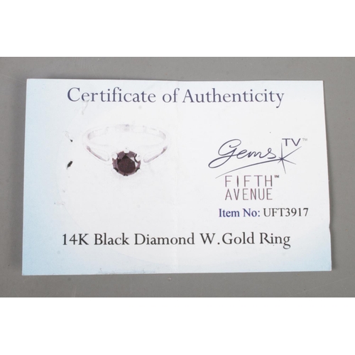 478 - A 14ct white gold black diamond solitaire ring. Size T with Gems TV certificate of authenticity. Gro... 