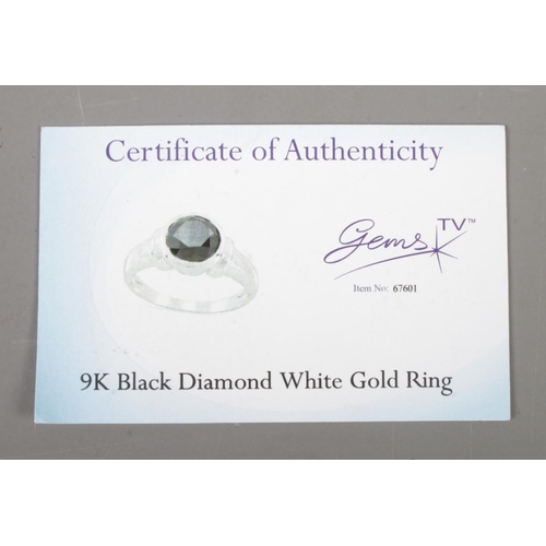 480 - A 9ct white gold black diamond solitaire ring. With Gems TV certificate with authenticity. Size S. G... 