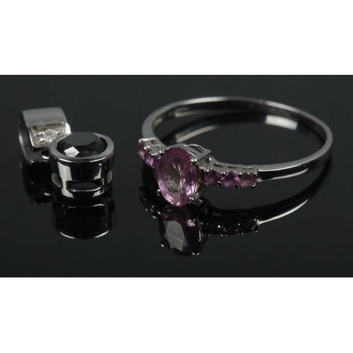 485 - A 9ct white gold ring featuring central pink stone (Size V, 1.65g) along with 9ct white gold black d... 