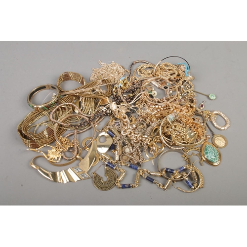 84 - A tray of yellow metal jewellery to include necklaces, bangles etc.