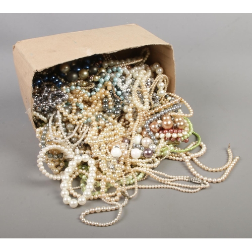 88 - A box containing a good collection of simulated pearl necklaces and bracelets