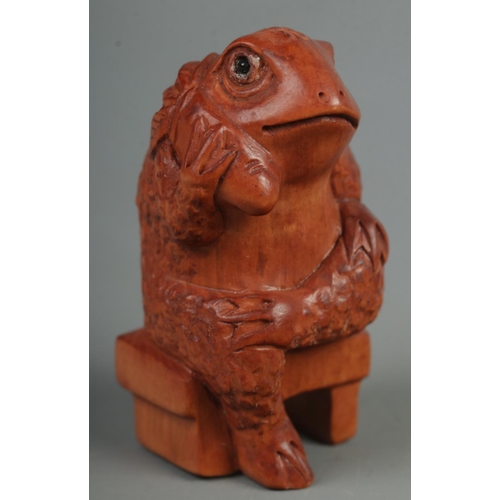 519 - A hand carved hardwood netsuke of a sitting frog